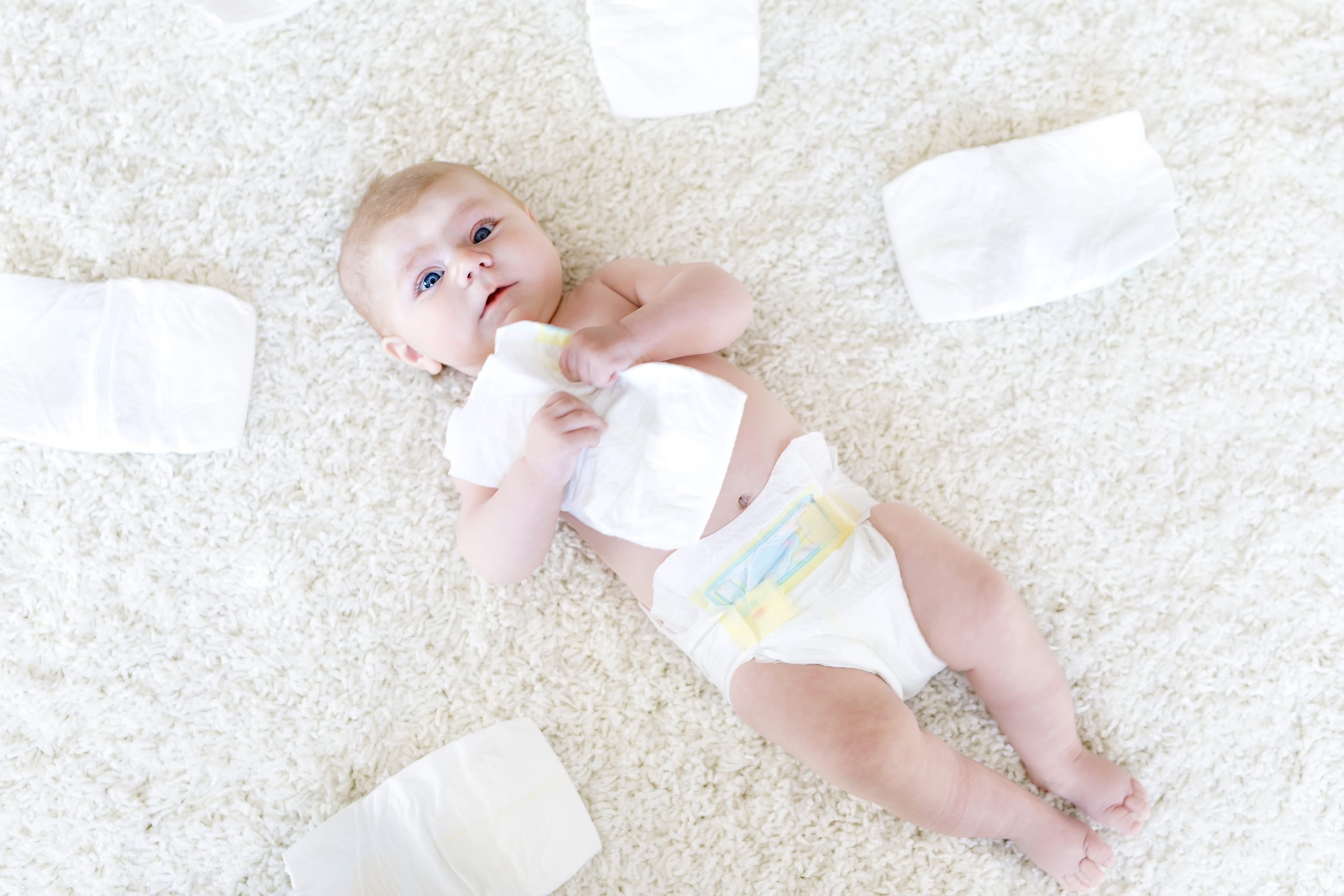 newborn baby girl with diapers. Dry skin and nursery