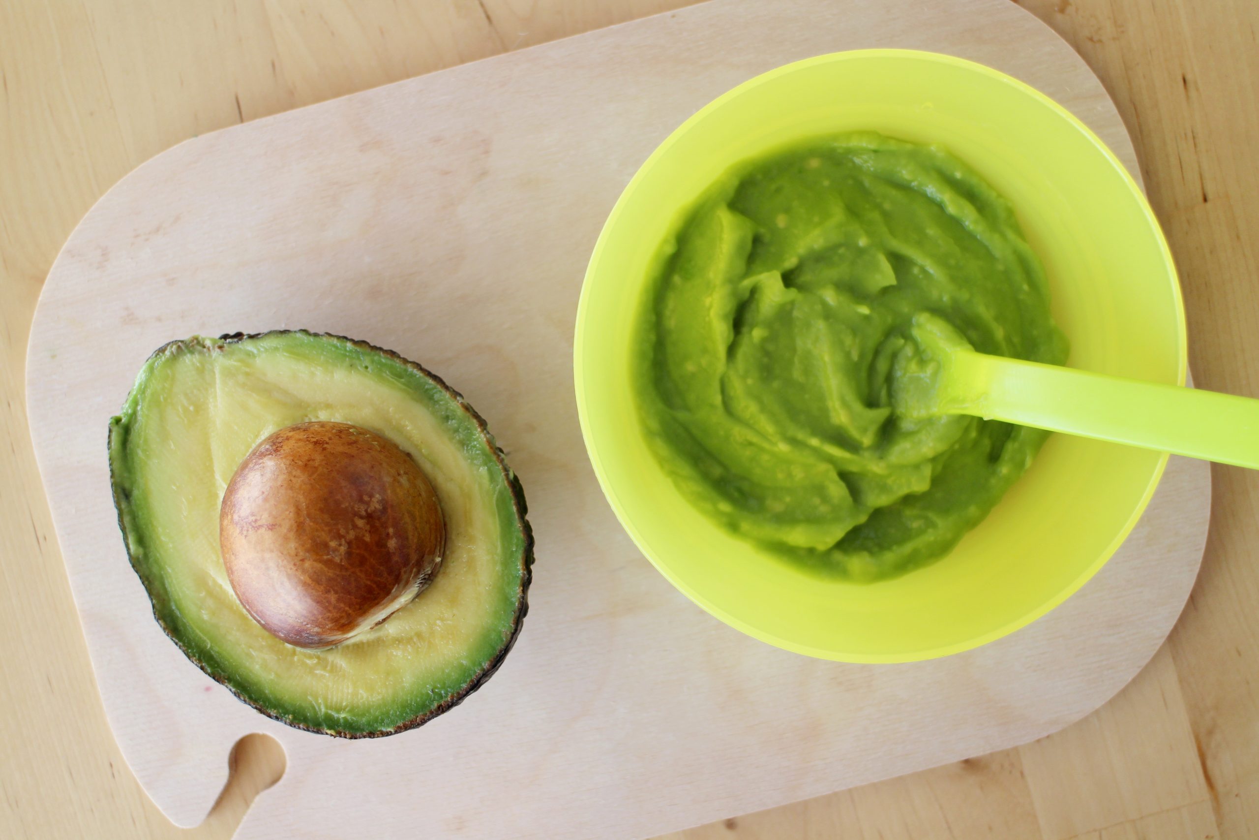 Avocado and Baby organic food avocado puree on a mat