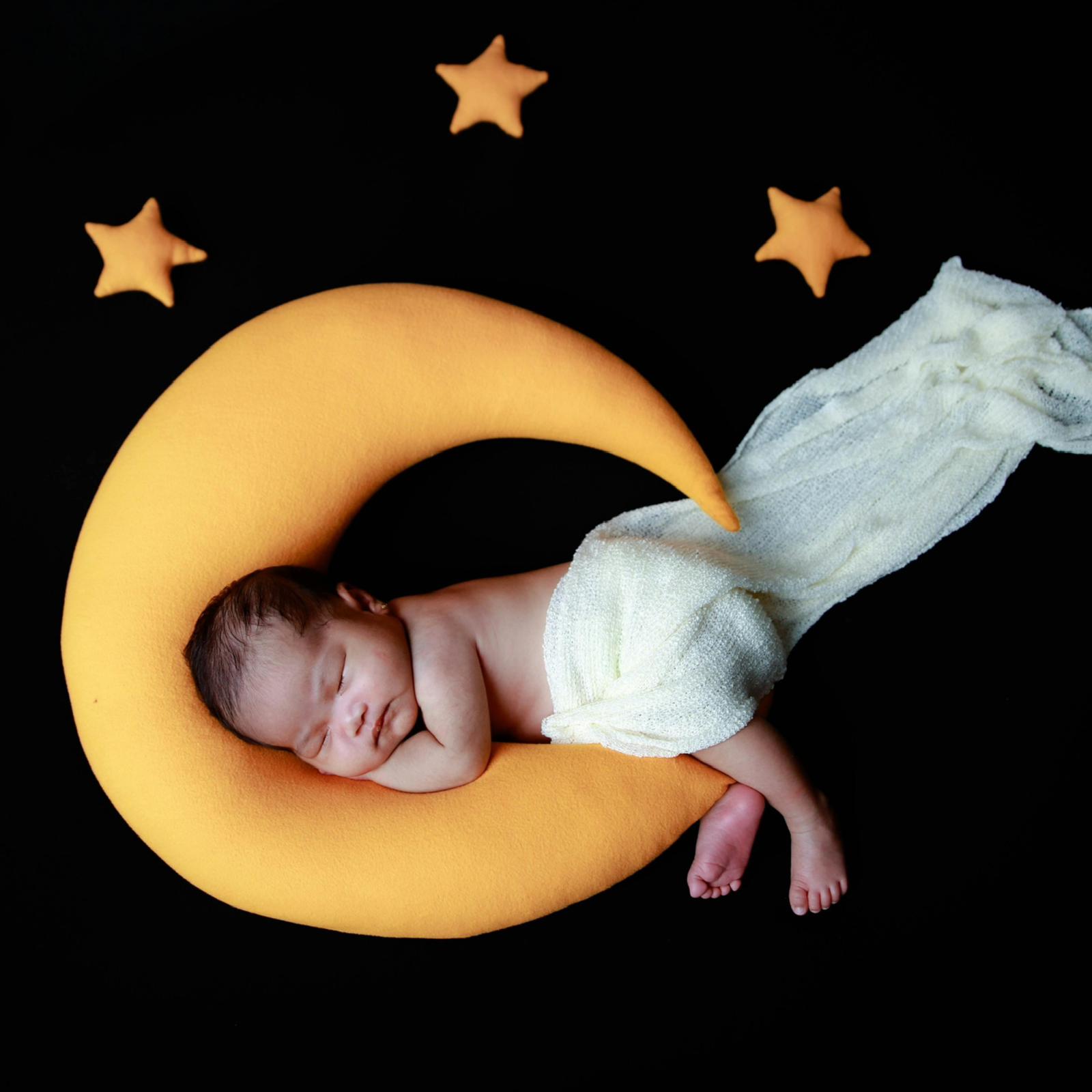 Baby asleep on a C-Moon shaped pillow